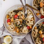 Creamy Fettuccine with Roasted Butternut Squash and Broccolini. Three plates filled with fettuccine pasta, creamy vegan sauce, roasted butternut squash, roasted grape tomatoes, and fresh roasted broccolini.