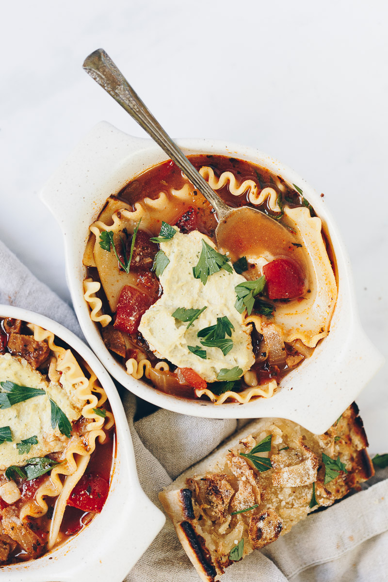 Vegan Lasagna Soup by Pasta-based. Warm, hearty, light and creamy vegan soup made with vegetable broth, lots of garlic, vegan sausage crumbles, fire-roasted tomatoes and lasagna noodles.