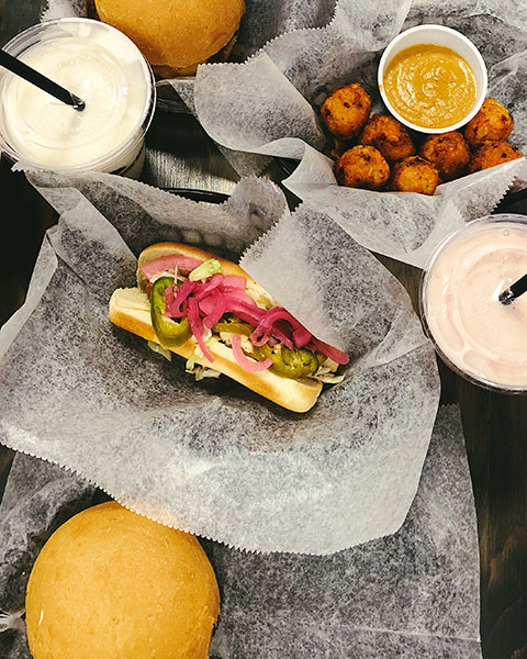 The Ultimate Guide to the BEST Vegan Food in Denver. Lunch at MetaBurger - vegan hot dog, two milkshakes, and meta-bites.