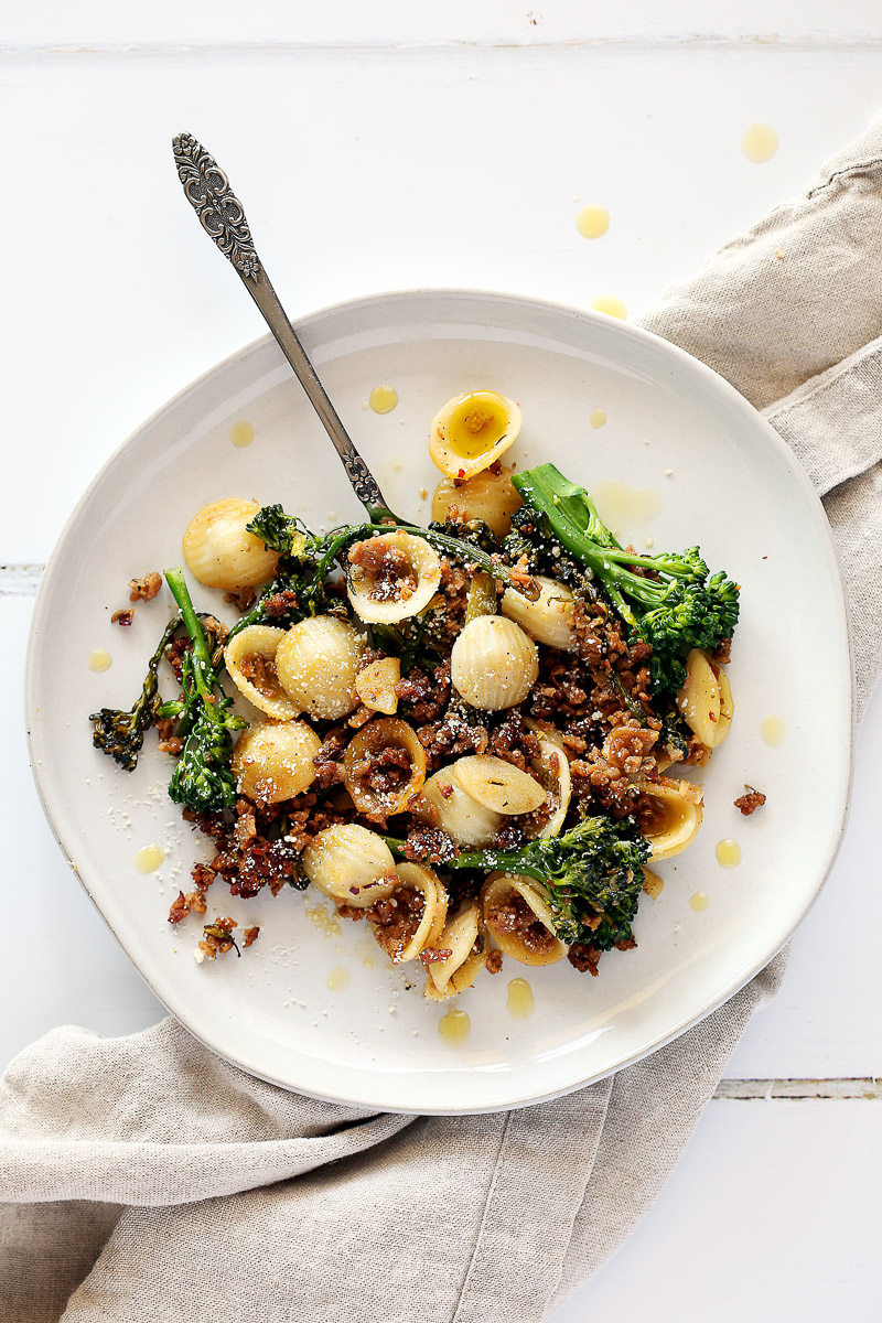 Italian Sausage Crumbles by Pasta-based. A plate of orecchiette pasta mixed with broccolini, vegan sausage crumbles, and fresh browned garlic.