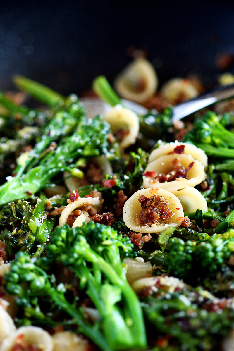 Italian Sausage Crumbles by Pasta-based. A pan filled with orecchiette pasta, broccolini, vegan sausage crumbles, and fresh browned garlic.