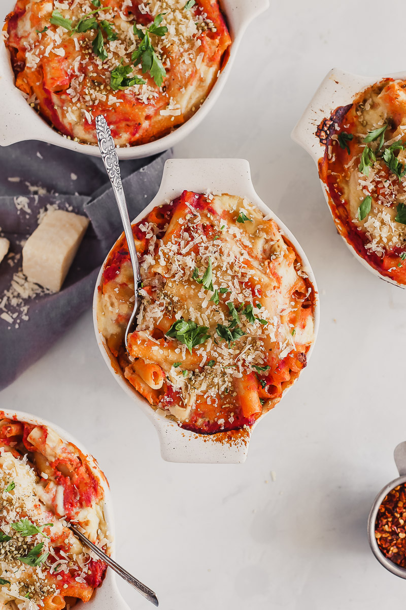 Vegan Baked Ziti by Pasta-based. Cheesy, saucy, creamy baked ziti bubbling over a small crockpot sprinkled with vegan parmesan and fresh parsley.