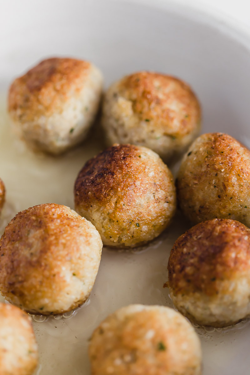 Golden brown vegan meatballs fried in oil. Option to bake available, too.