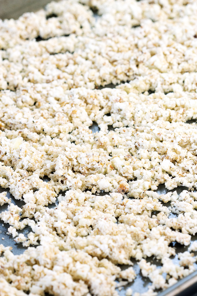 Cauliflower and walnut finely pulsed in a food processor and spread on a baking sheet ready to go into the oven.