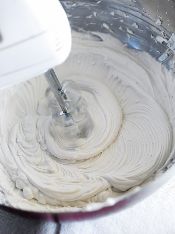 vegan whipped cream in a stainless steel bowl.