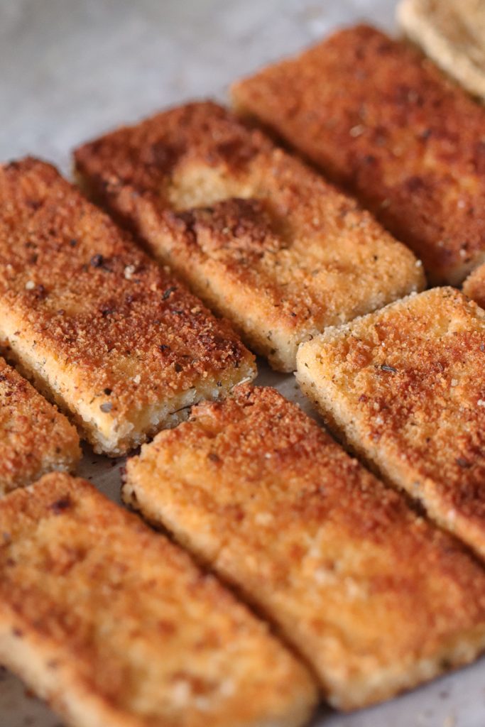 Close up image of browned crispy tofu cutlets.