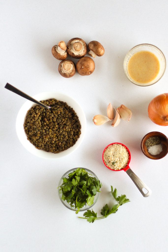 Vegan Meatballs Recipe by Pasta-based. Lentils, Italian-seasoned breadcrumbs, cremini baby bella mushrooms, fresh onion, fresh garlic cloves, flax egg, fresh parsley, and salt and pepper in a small wooden bowl.