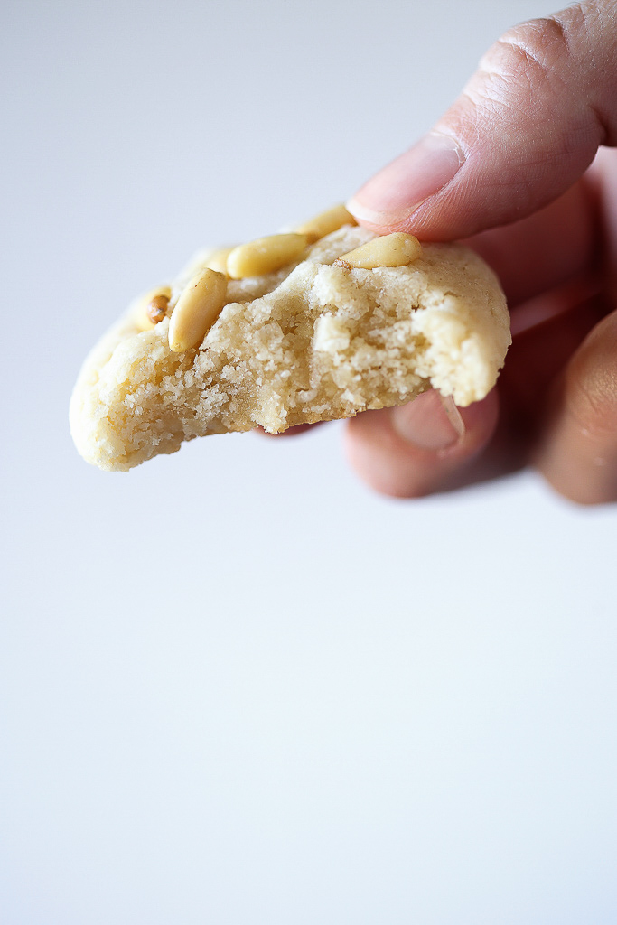 Someone took a bite out of the moist, chewy cookie and is showing the detail of how soft and fluffy the cookie is.