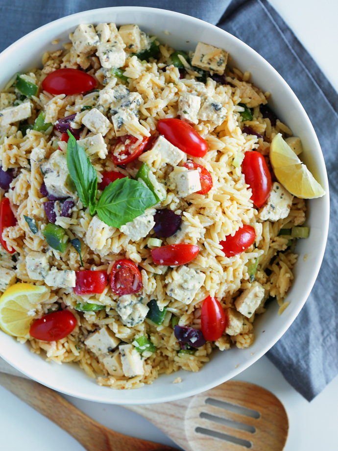 Orzo pasta salad with grape tomatoes, kalamata olives, green bell pepper, and homemade tofu feta tossed in a Dijon Mustard Vinaigrette