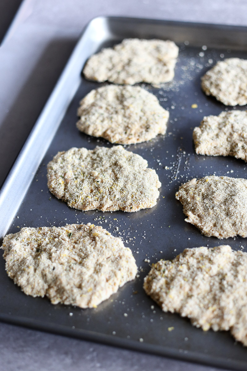 Vegan Seitan Parmesan by Pasta-based. Vegan seitan cutlets on a baking sheet before going into the oven. 