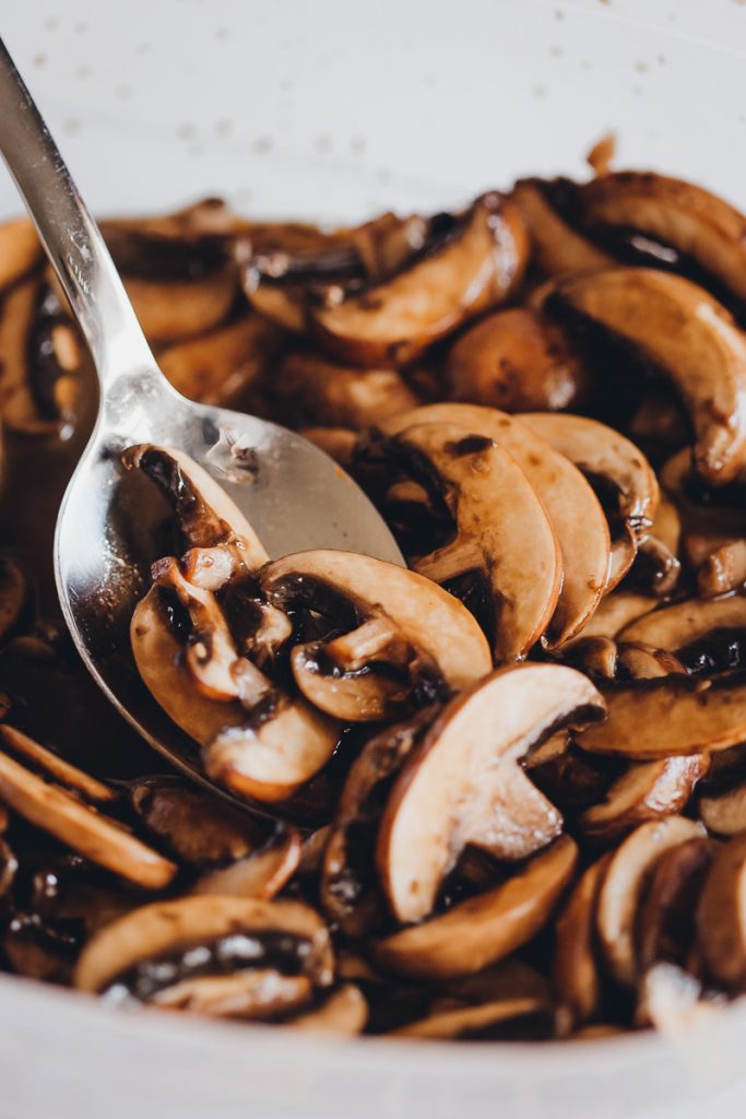 Vegan Spaghetti Carbonara by Pasta-based. Marinated baby bella mushrooms with a silver spoon..