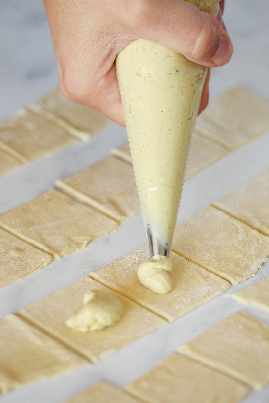 We used a piping bag to distribute the ricotta in the center of each square of dough. You can always use a teaspoon to measure the ricotta, but a piping bag makes the process much quicker.