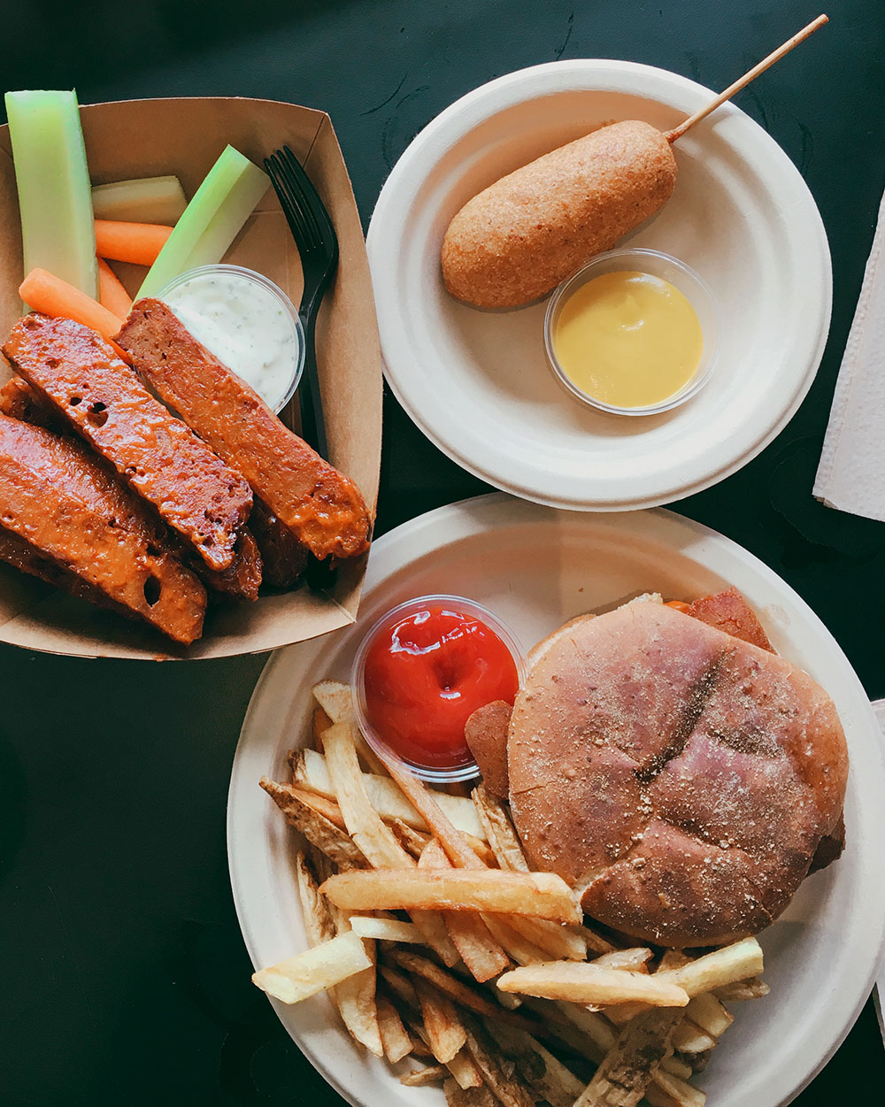 The Ultimate Guide to the BEST Vegan Food in Denver. Seitan wings, corndog, burger and fries from Vegan Van Food Truck.