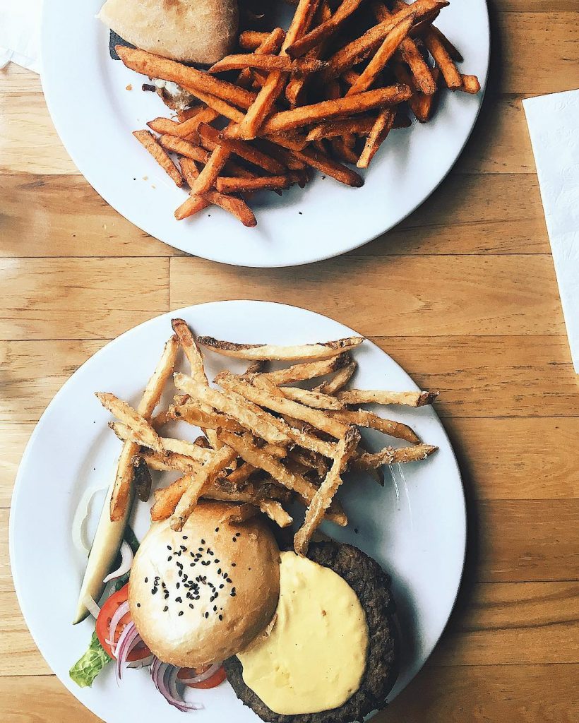 The Ultimate Guide to the BEST Vegan Food in Denver. A burger and fries from WaterCourse Foods.